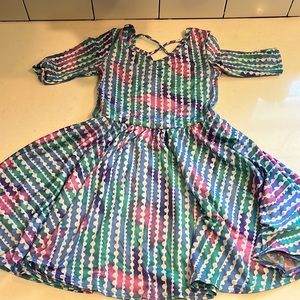 Girls DotDot Smile twirl dress, light blue with pink and purple. Cross back.